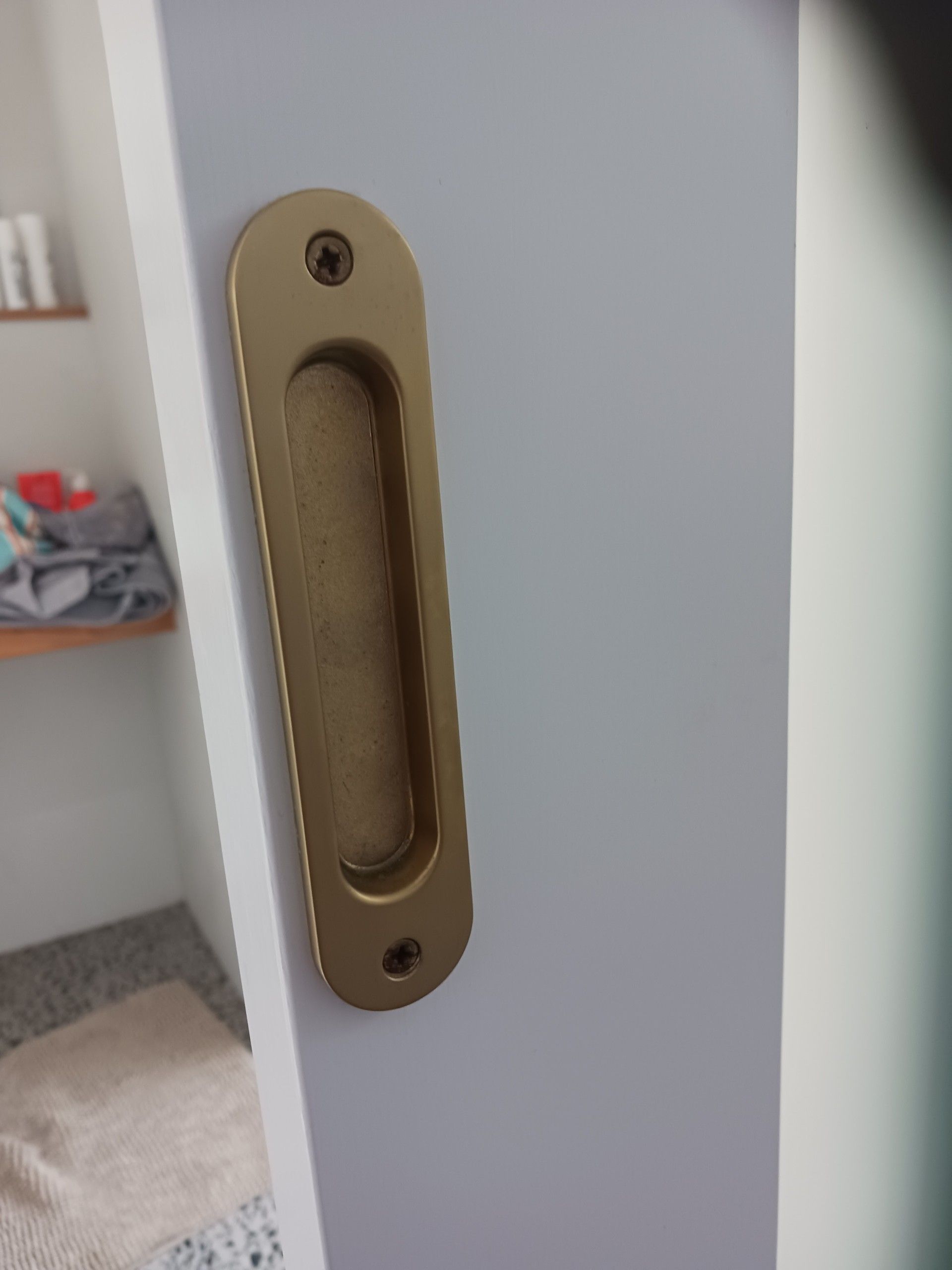 Gold, recessed sliding door handle on a white door— Yamba Locksmiths in Yamba, NSW