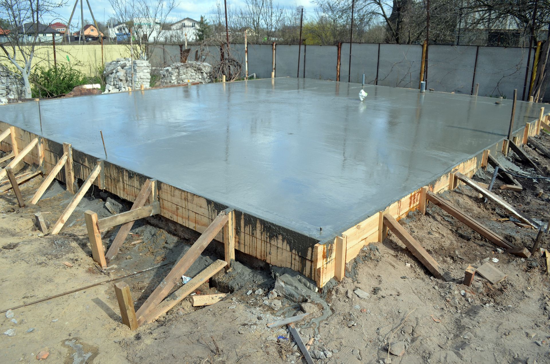 A close up of a concrete base for a house under construction.