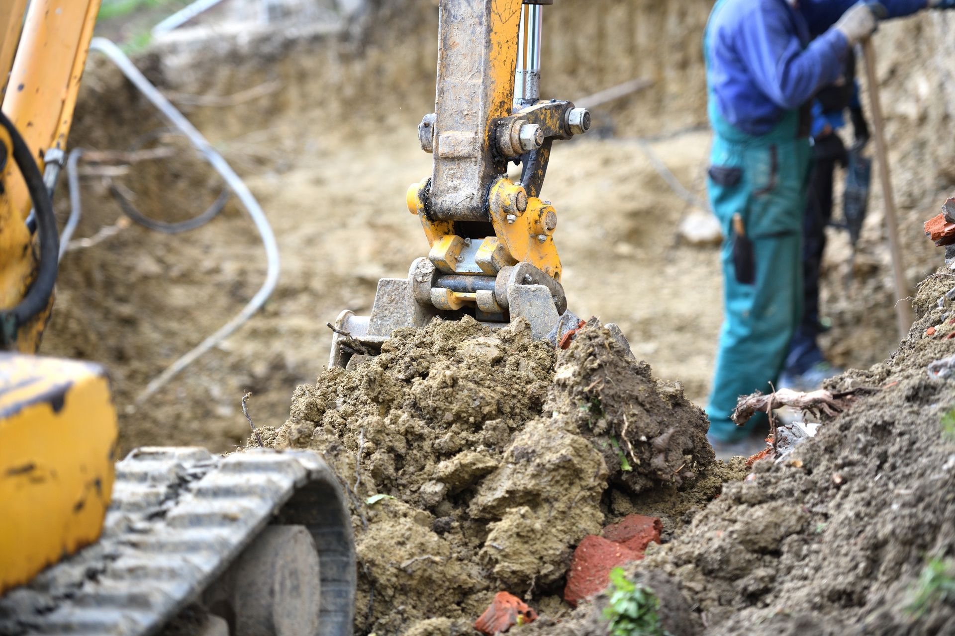 A man is digging a hole in the ground with a bulldozer.