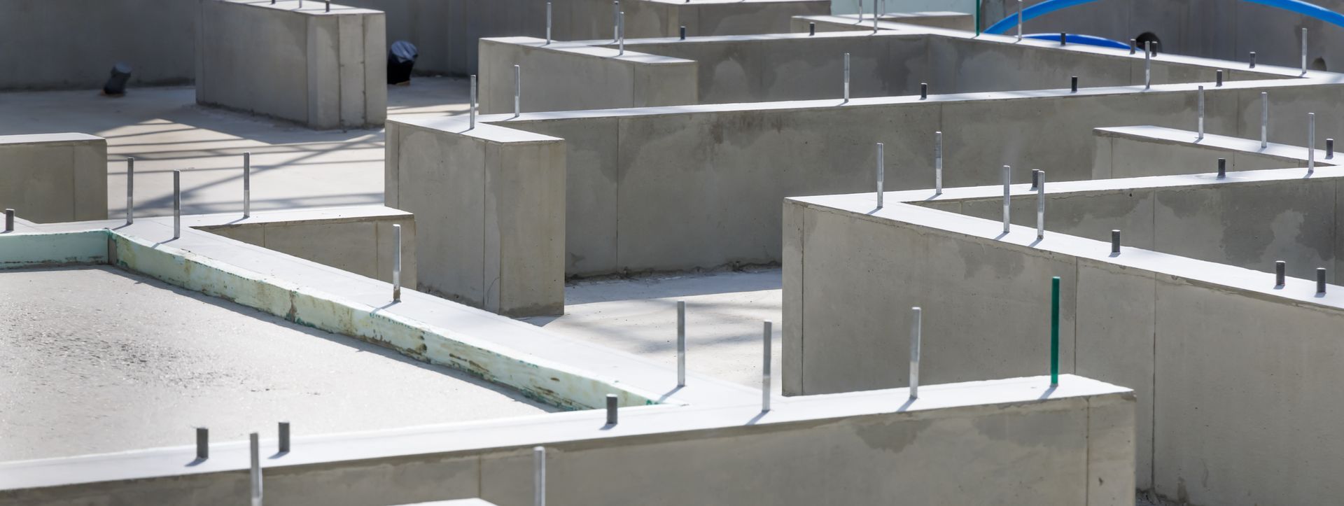 A close up of a concrete base for a house under construction.