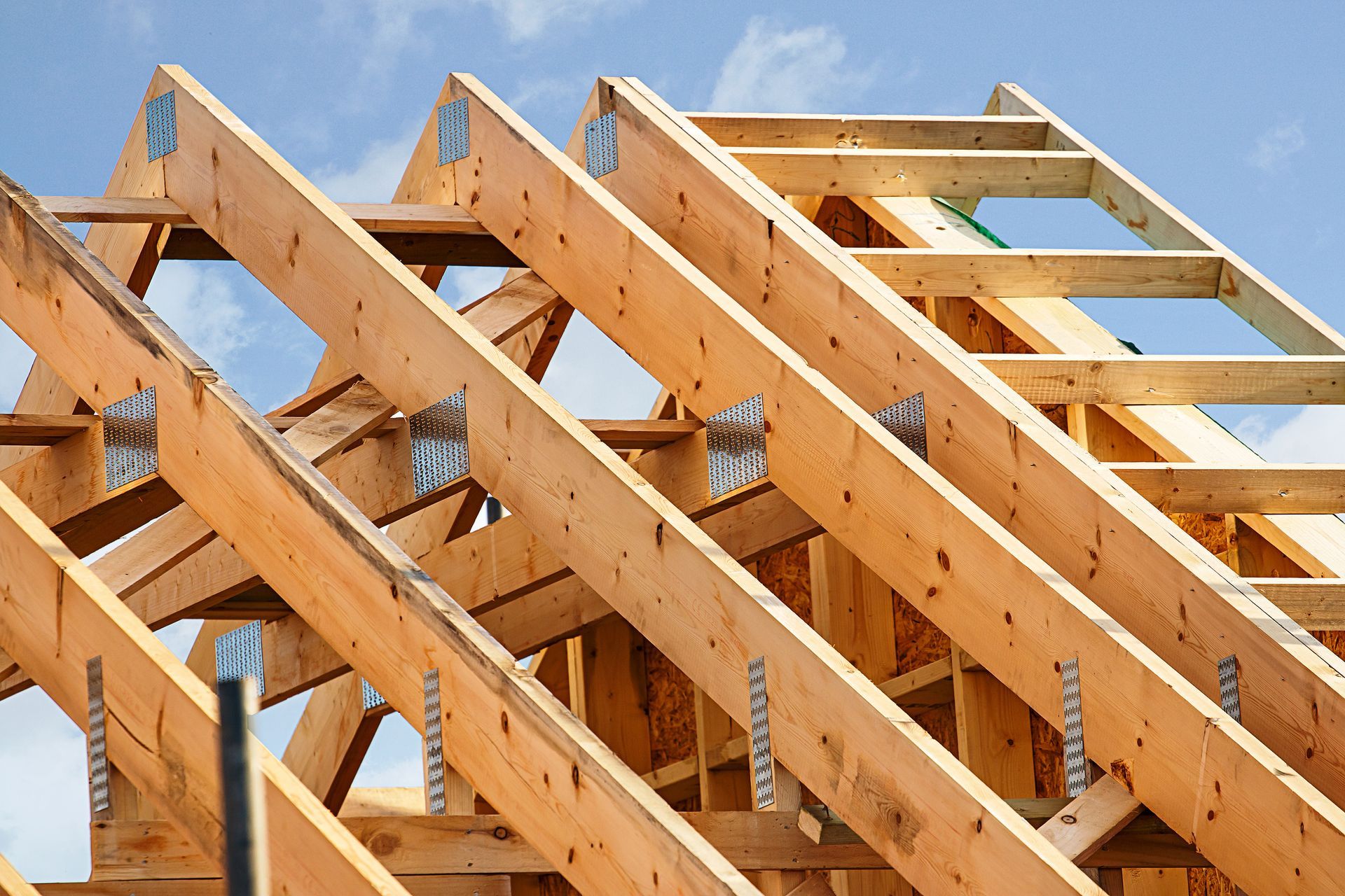 The roof of a house is being built with wooden beams