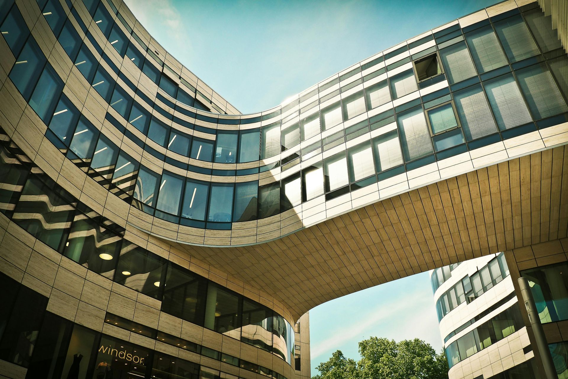 A large room with a lot of furniture and a lot of windows after refurbishment.