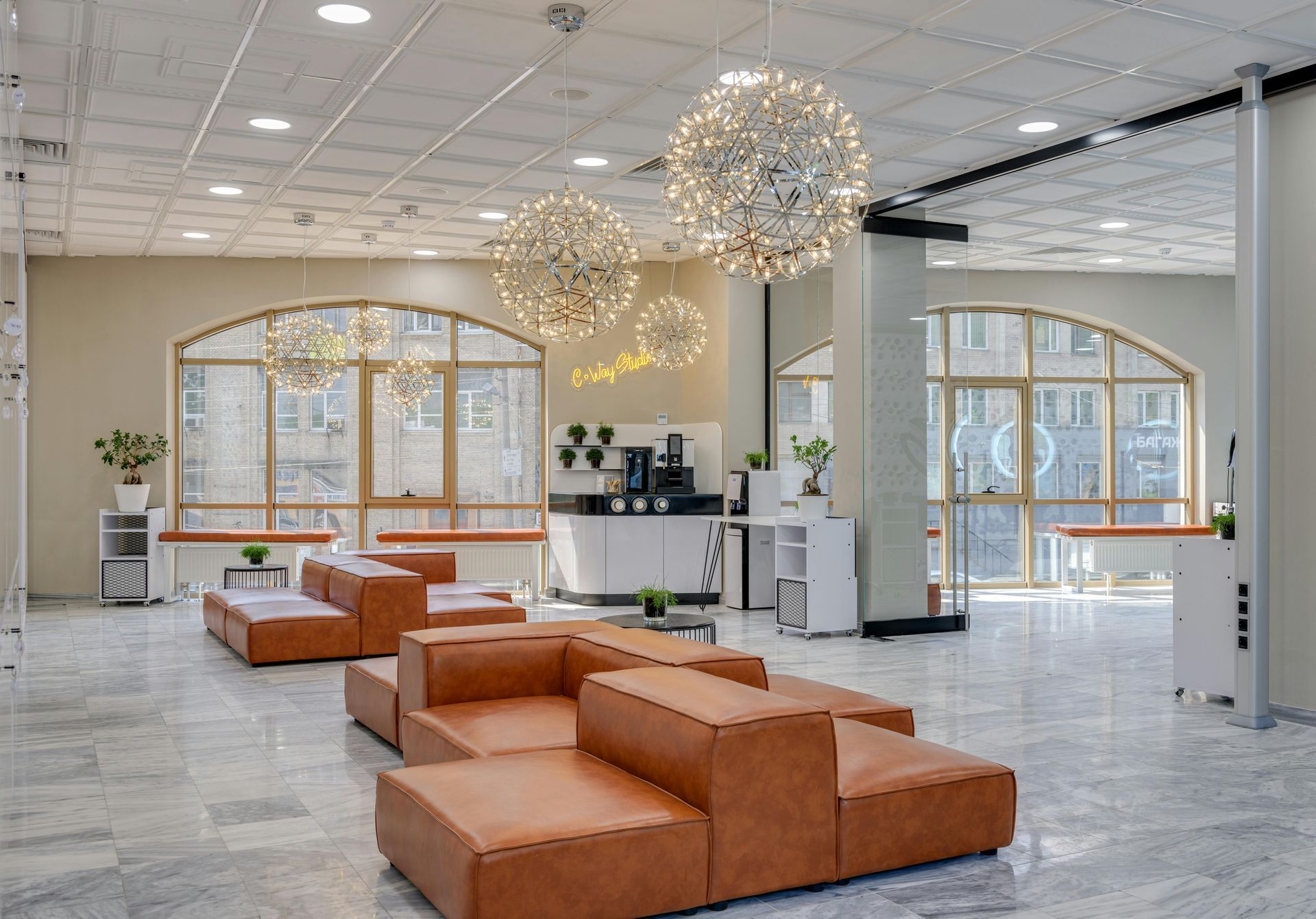 A large room with a lot of furniture and a lot of windows after refurbishment.