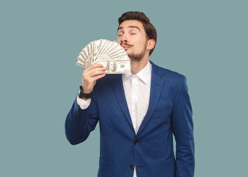 Pawn Shop Tv — Man Holding Money in Jonesboro, GA