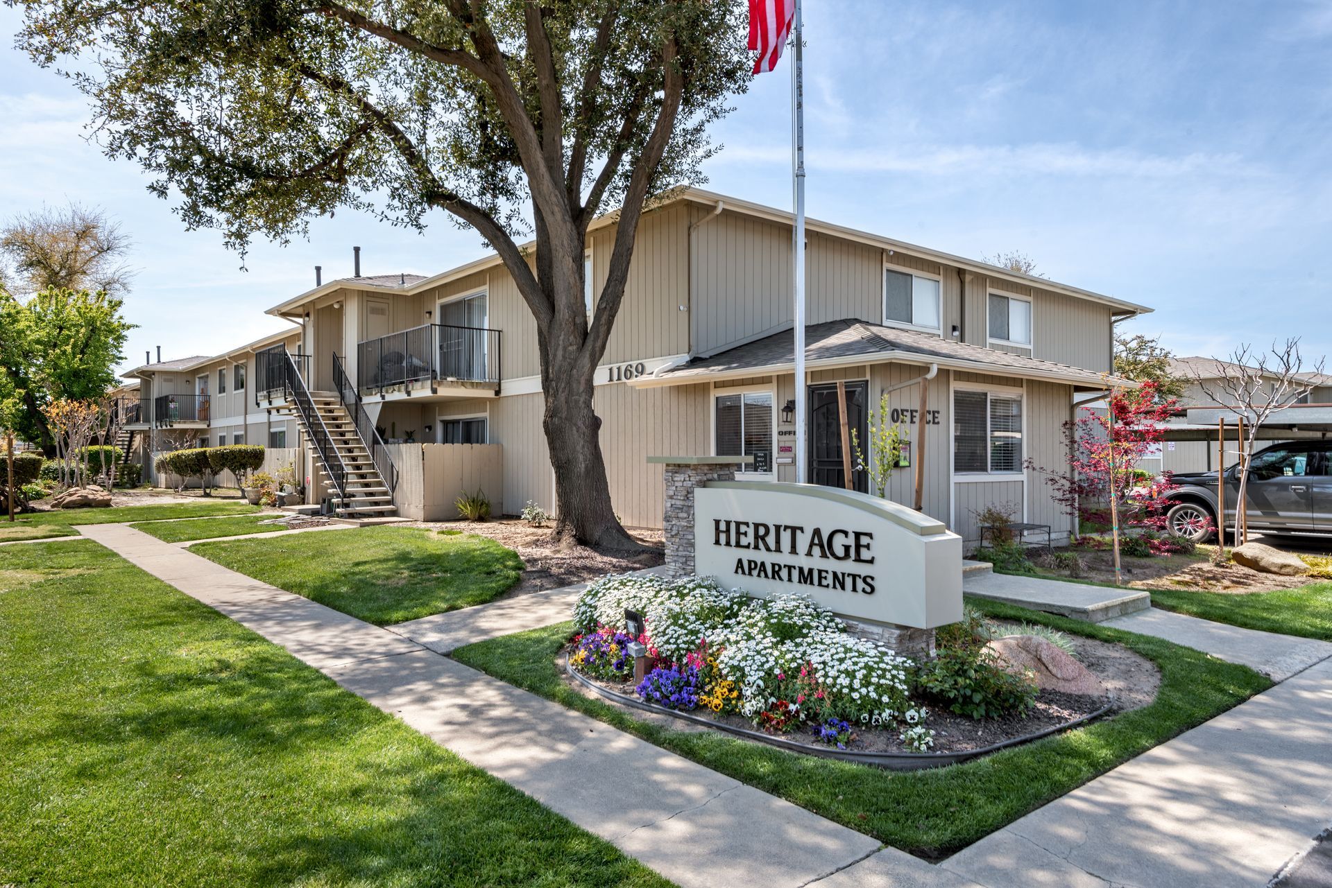 Heritage Apartments building with sign and landscaping.