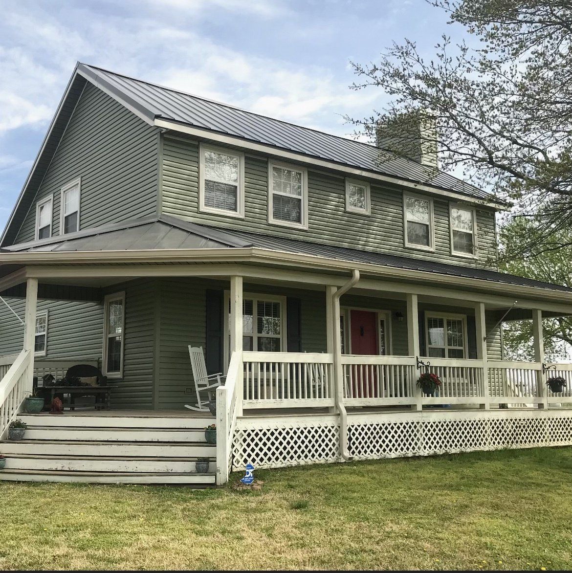 A large house with a large porch and stairs
