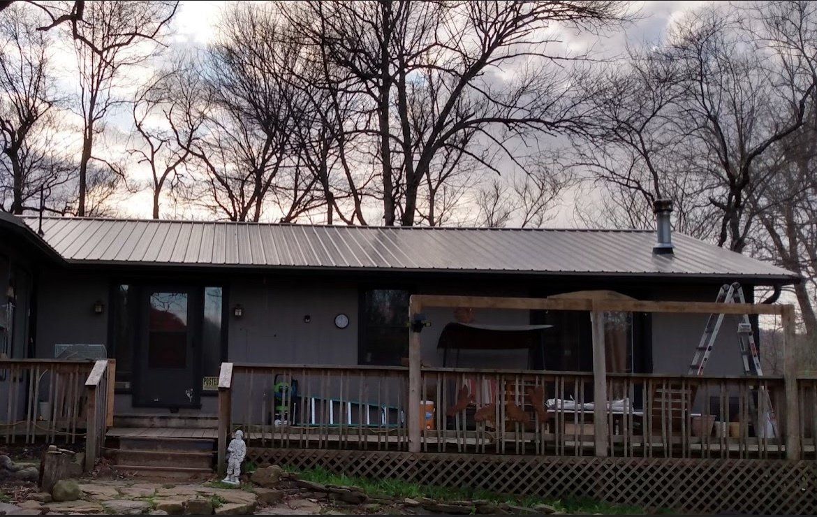 A house with a metal roof and a large deck