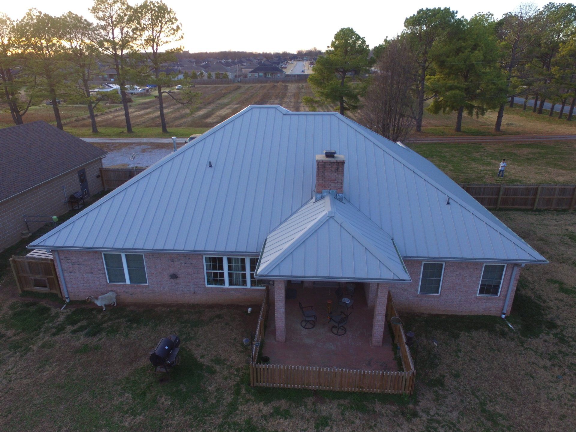 An aerial view of a house with a metal roof