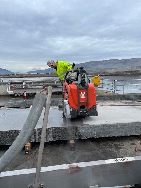 Worker using an equipment for cutting concrete — Vancouver, WA — Accurate Concrete Cutting