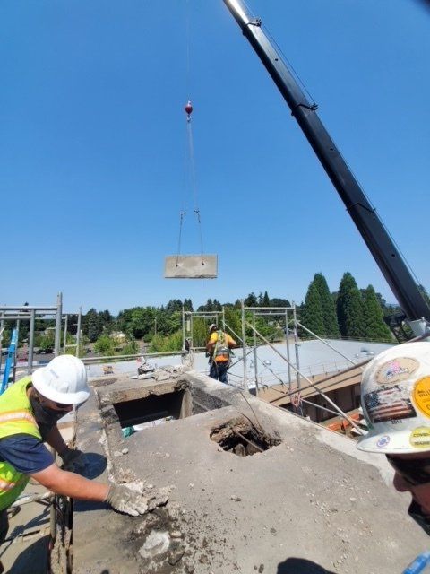 Men working on a large block of concrete ceiling — Vancouver, WA — Accurate Concrete Cutting