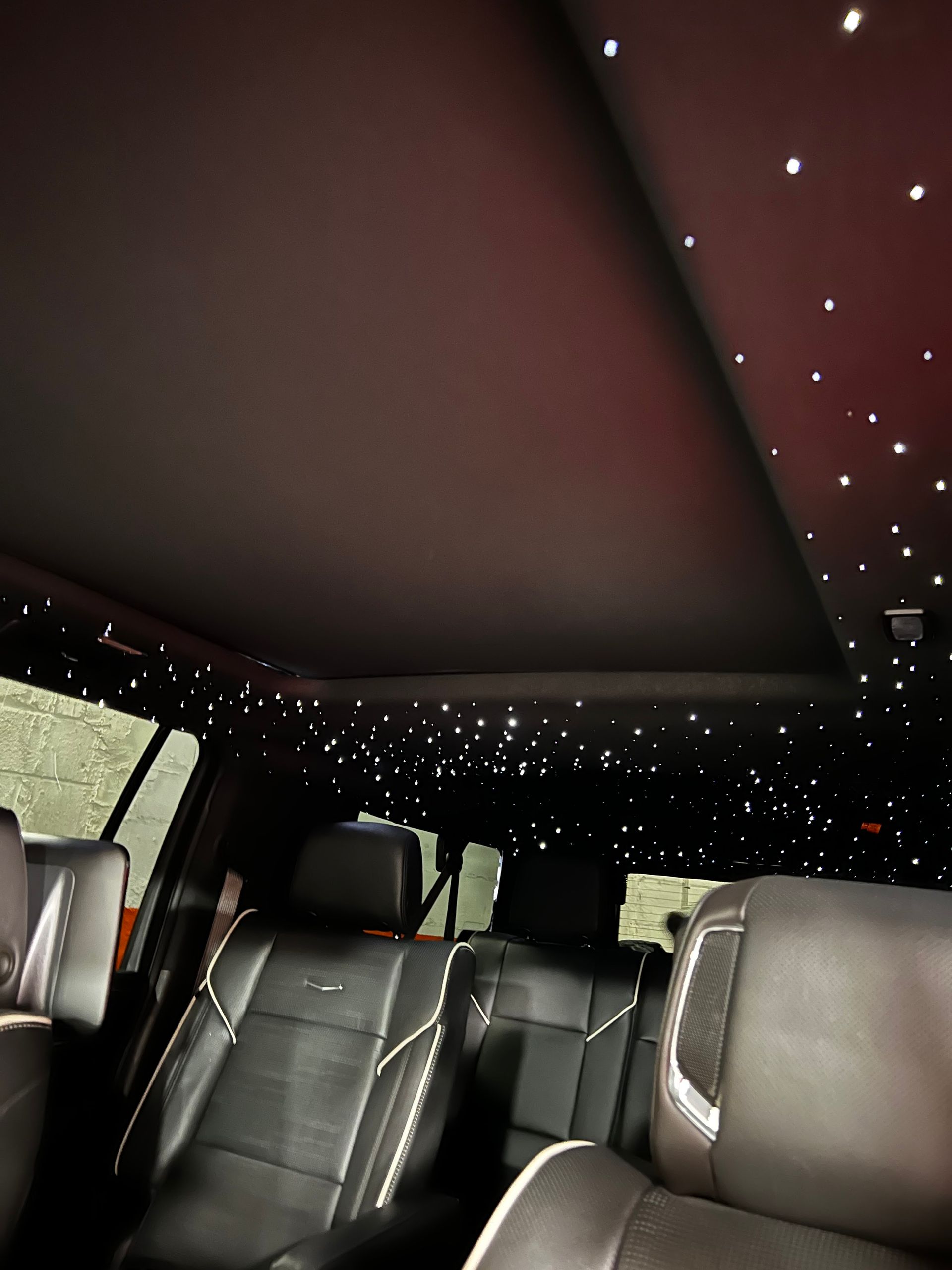 The inside of a car with a starry ceiling