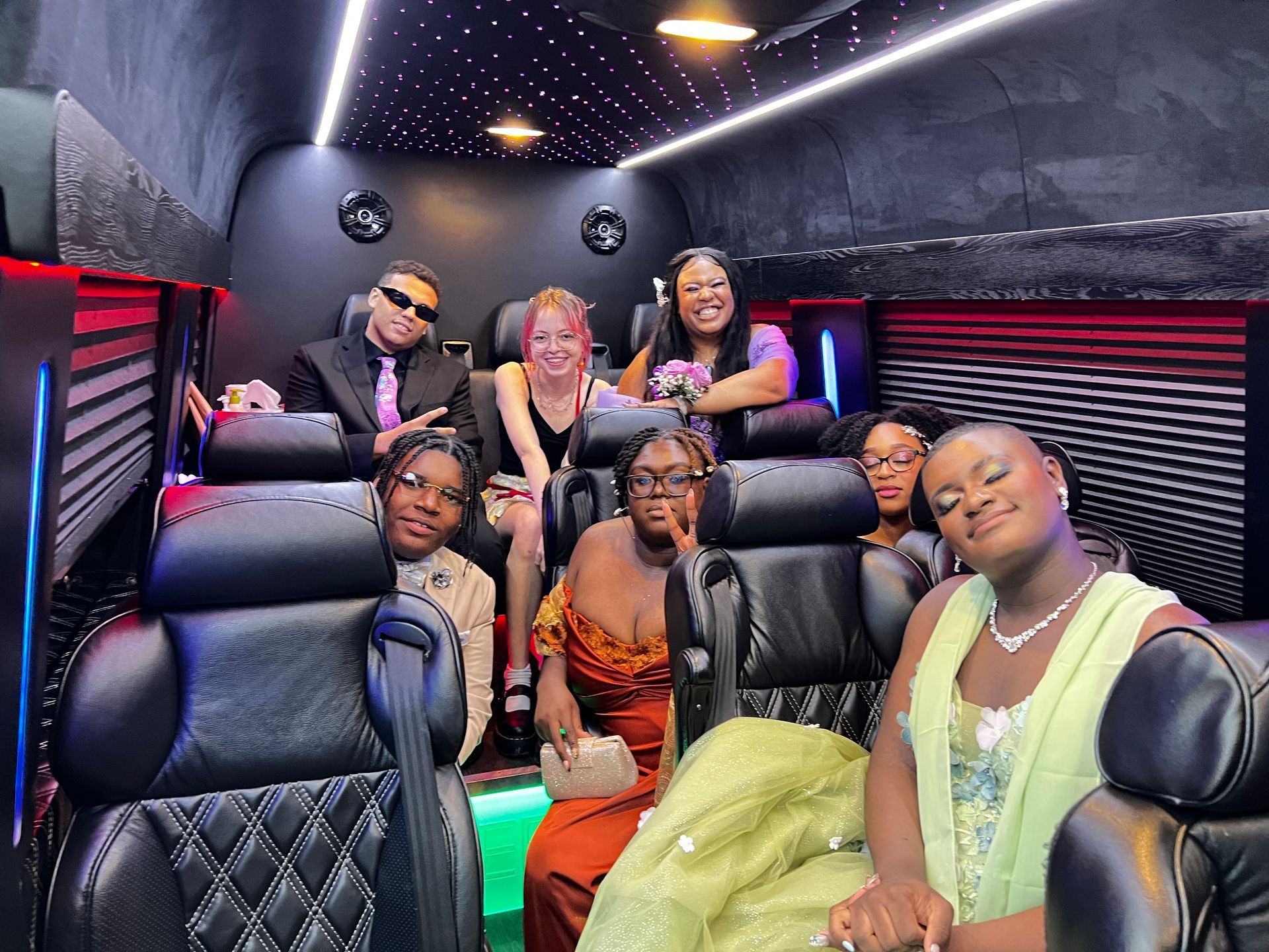 A group of people are posing for a picture in a van.