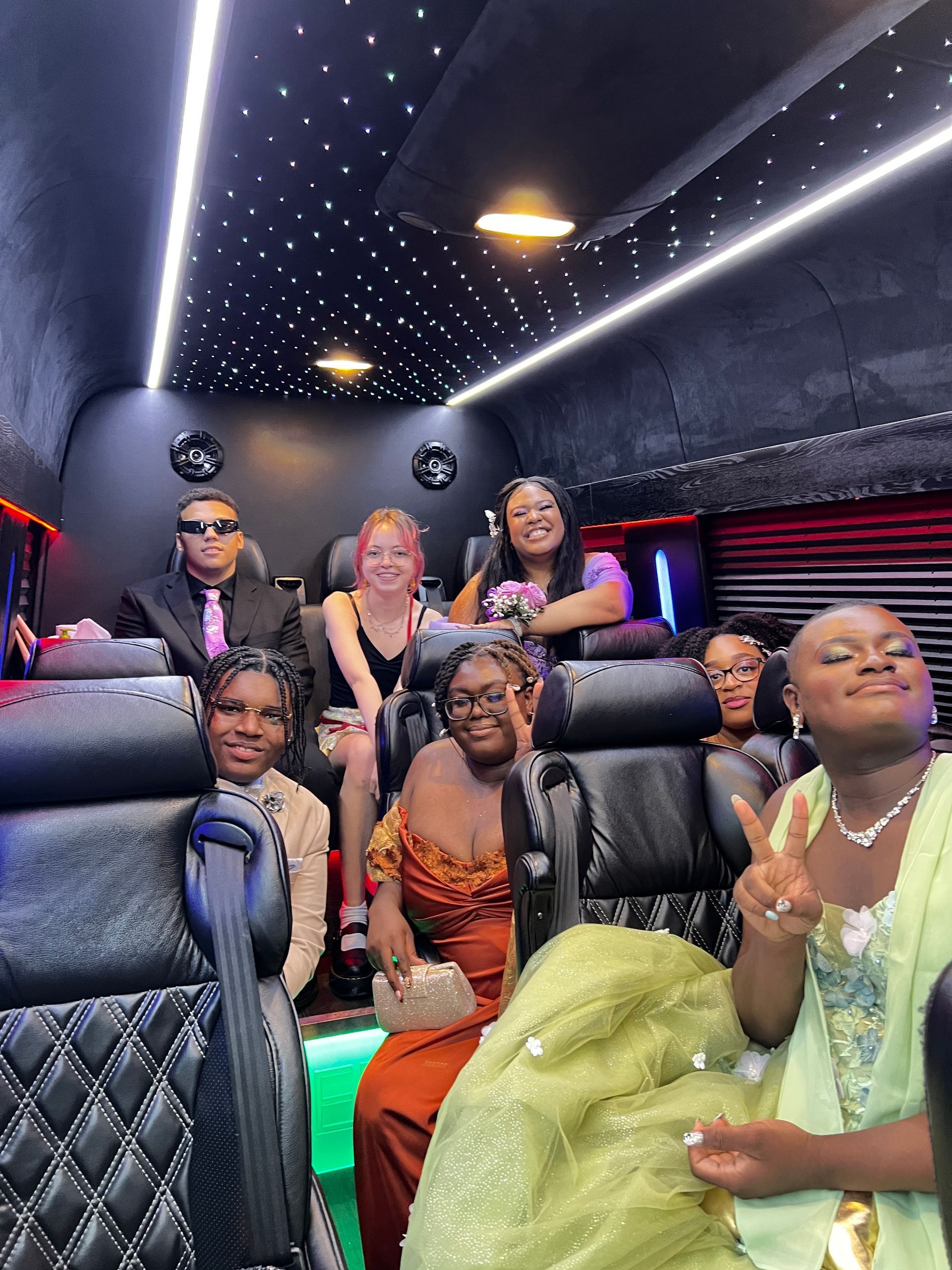 A group of people are sitting in a limousine.