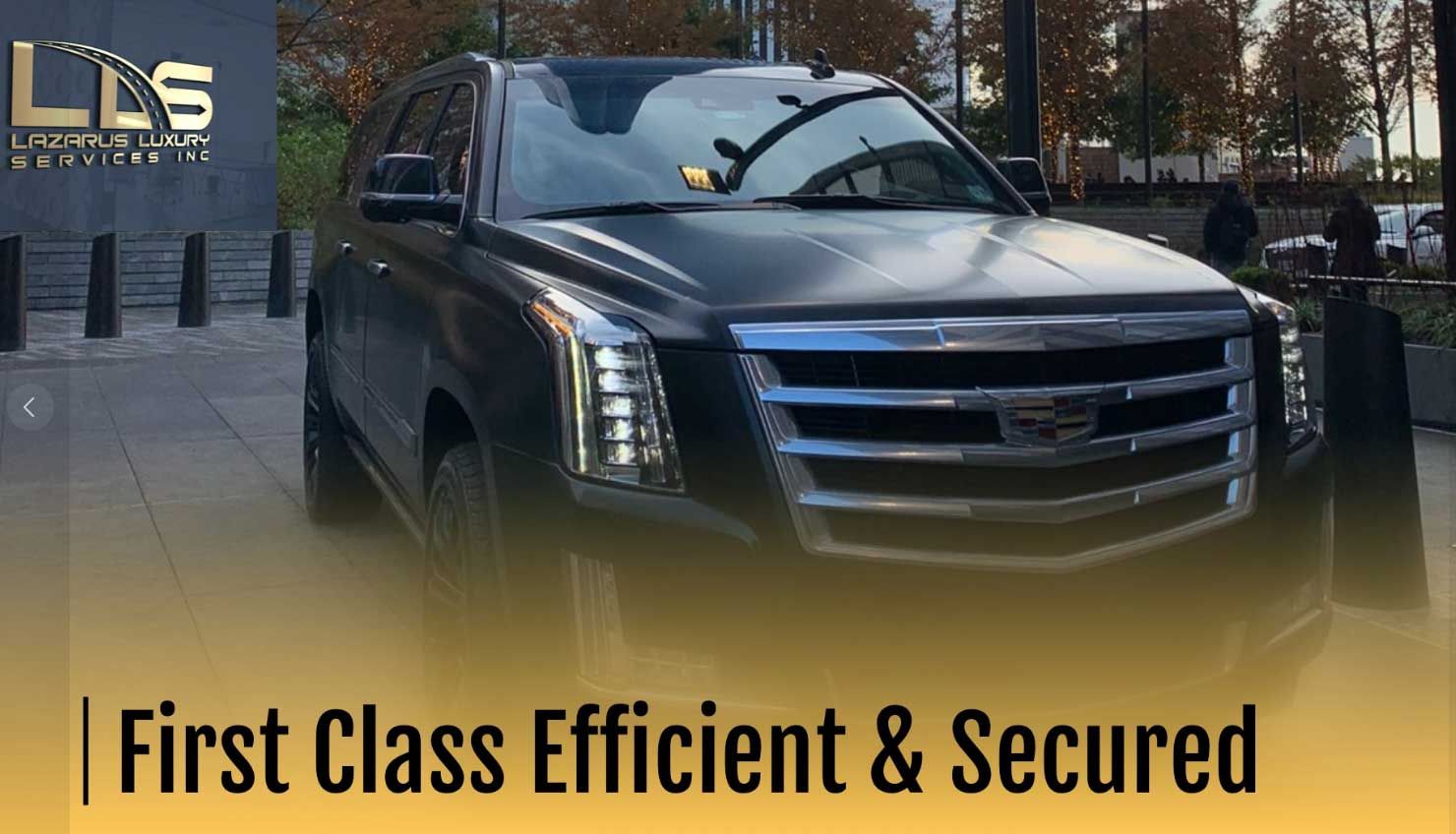 A black cadillac escalade is parked in a parking lot.