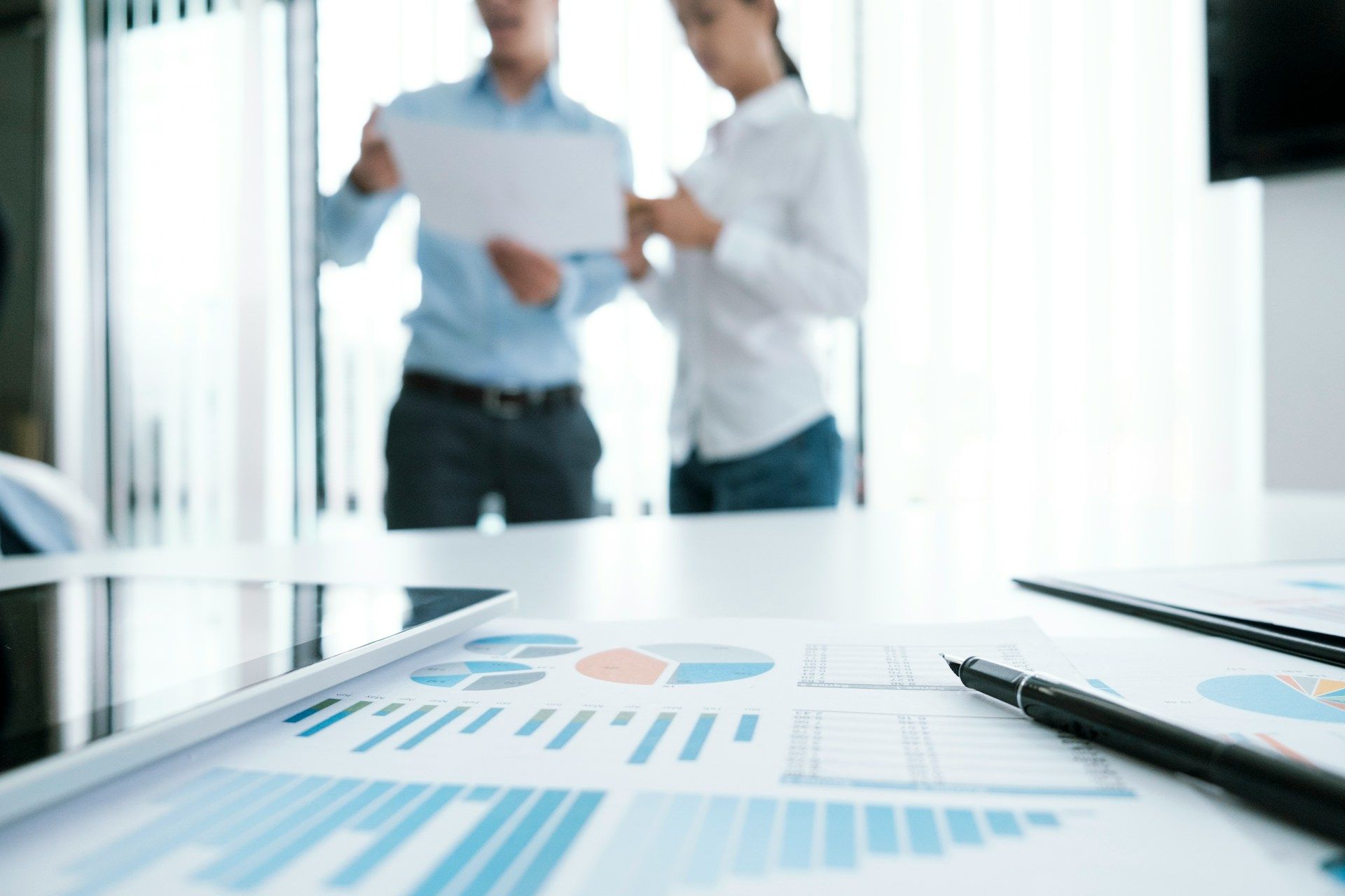 A woman is holding a baby while another woman looks on.