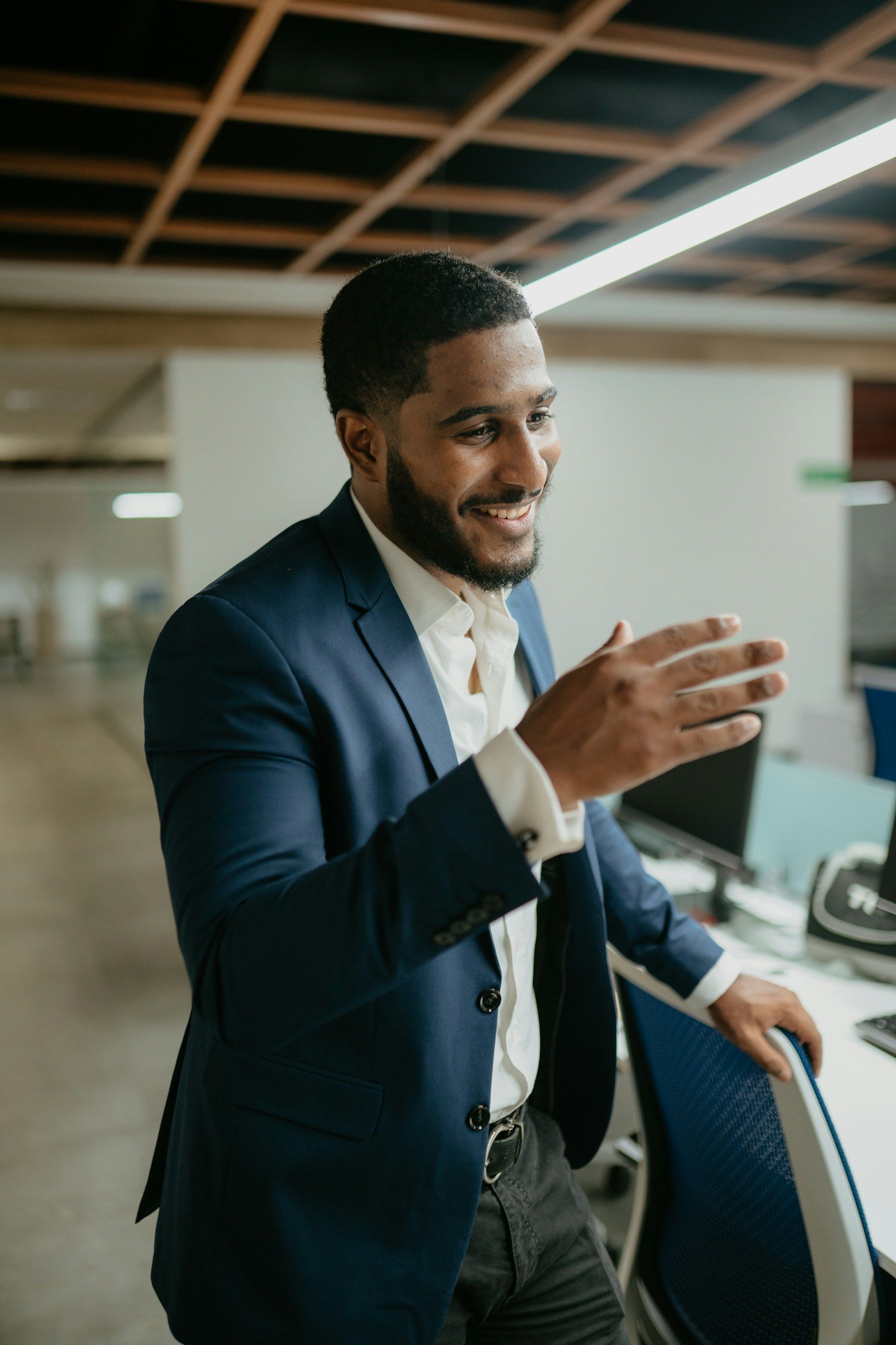 A group of women are sitting in a circle in a gym talking to each other.