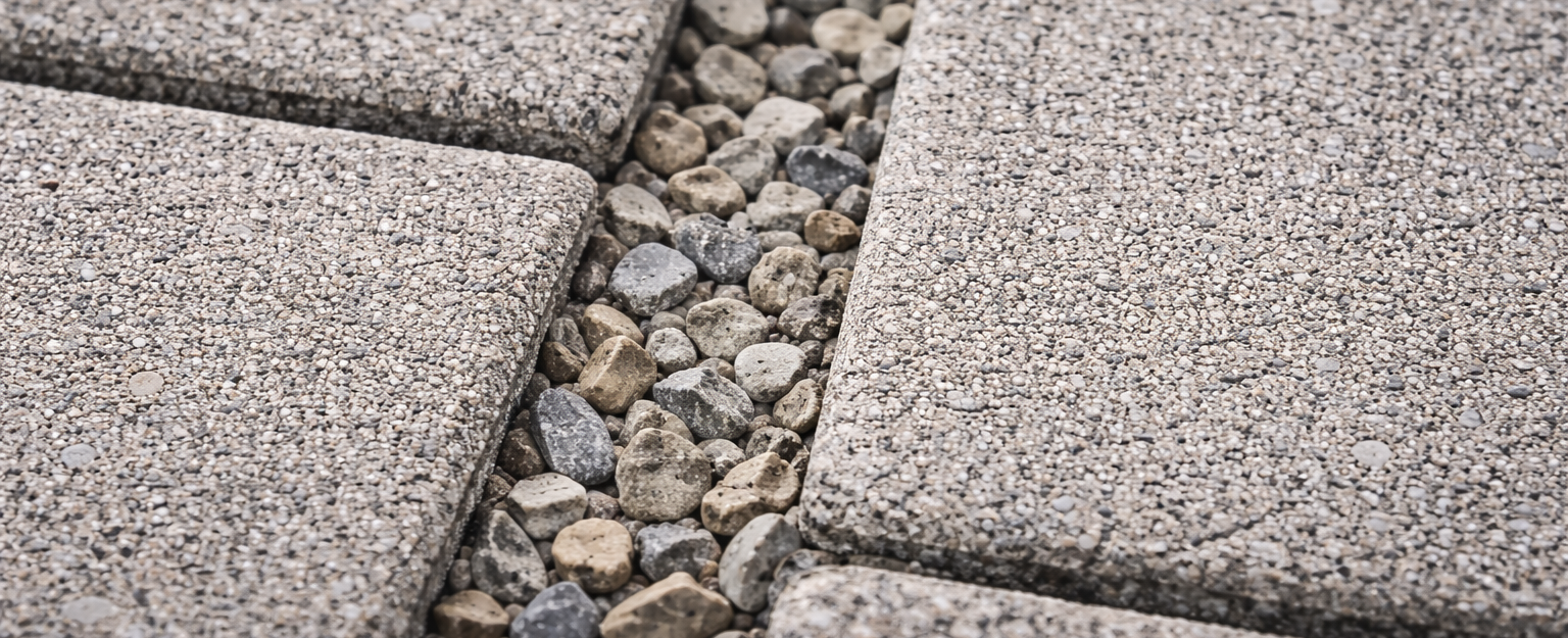 Close up of permeable paver joints filled with aggregate for drainage.