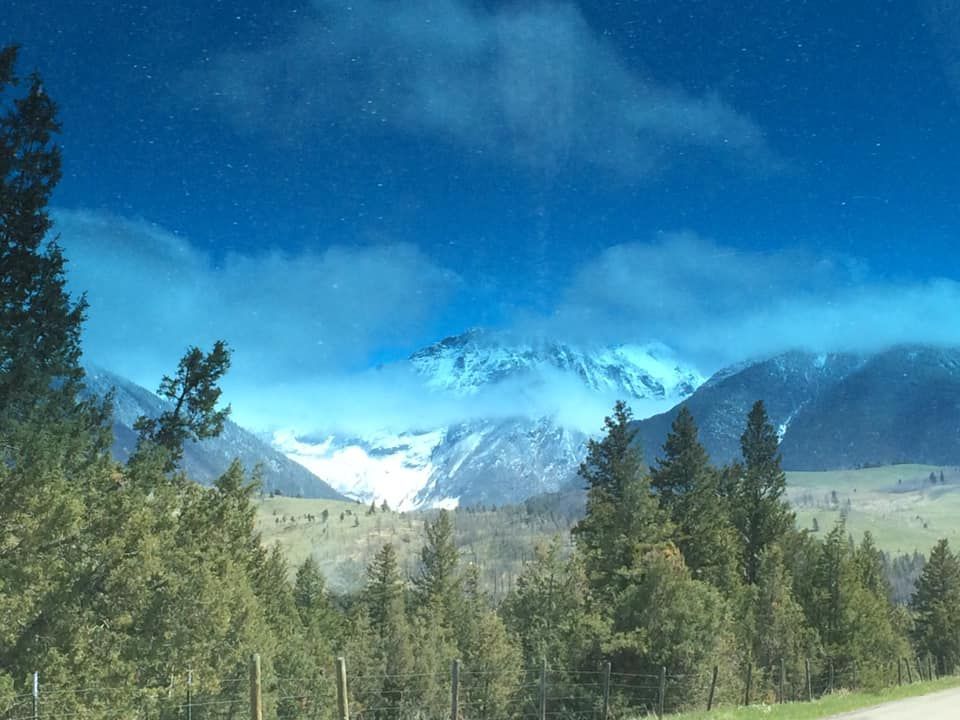 A view of a snowy mountain from a car window