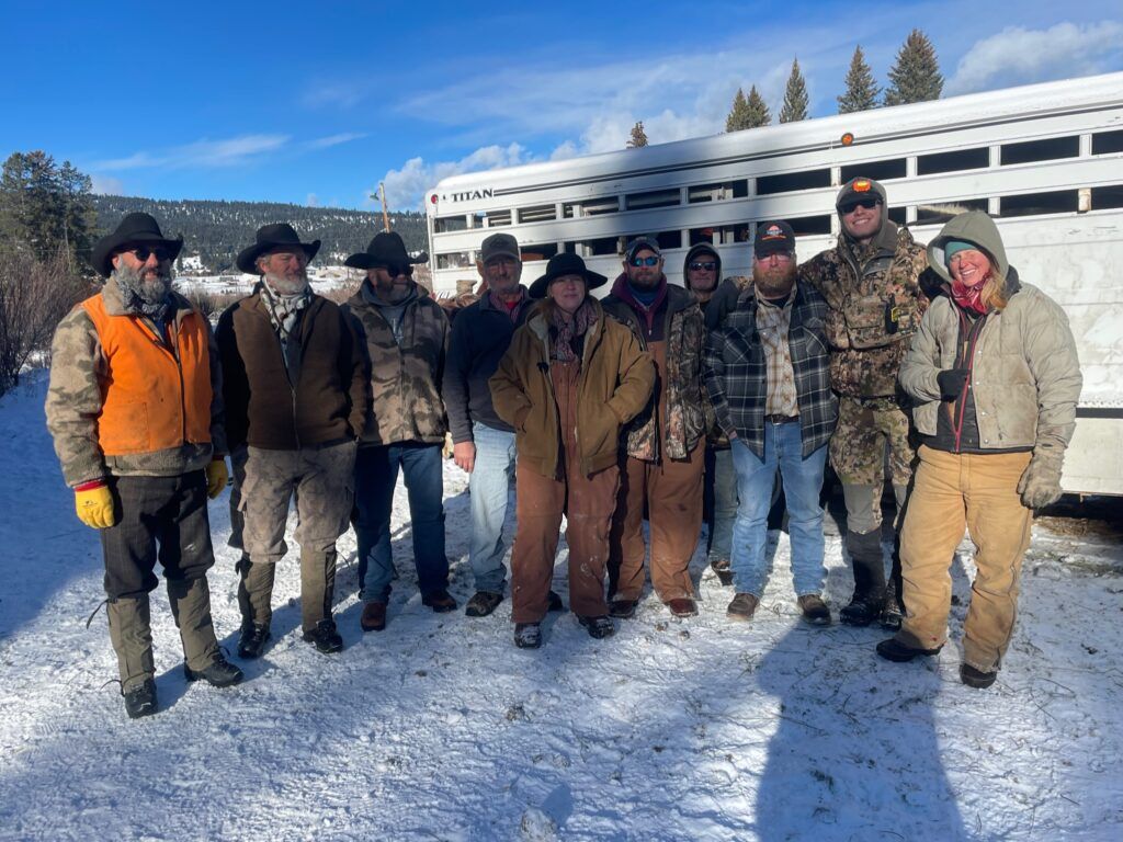A group of men are posing for a picture in the snow.
