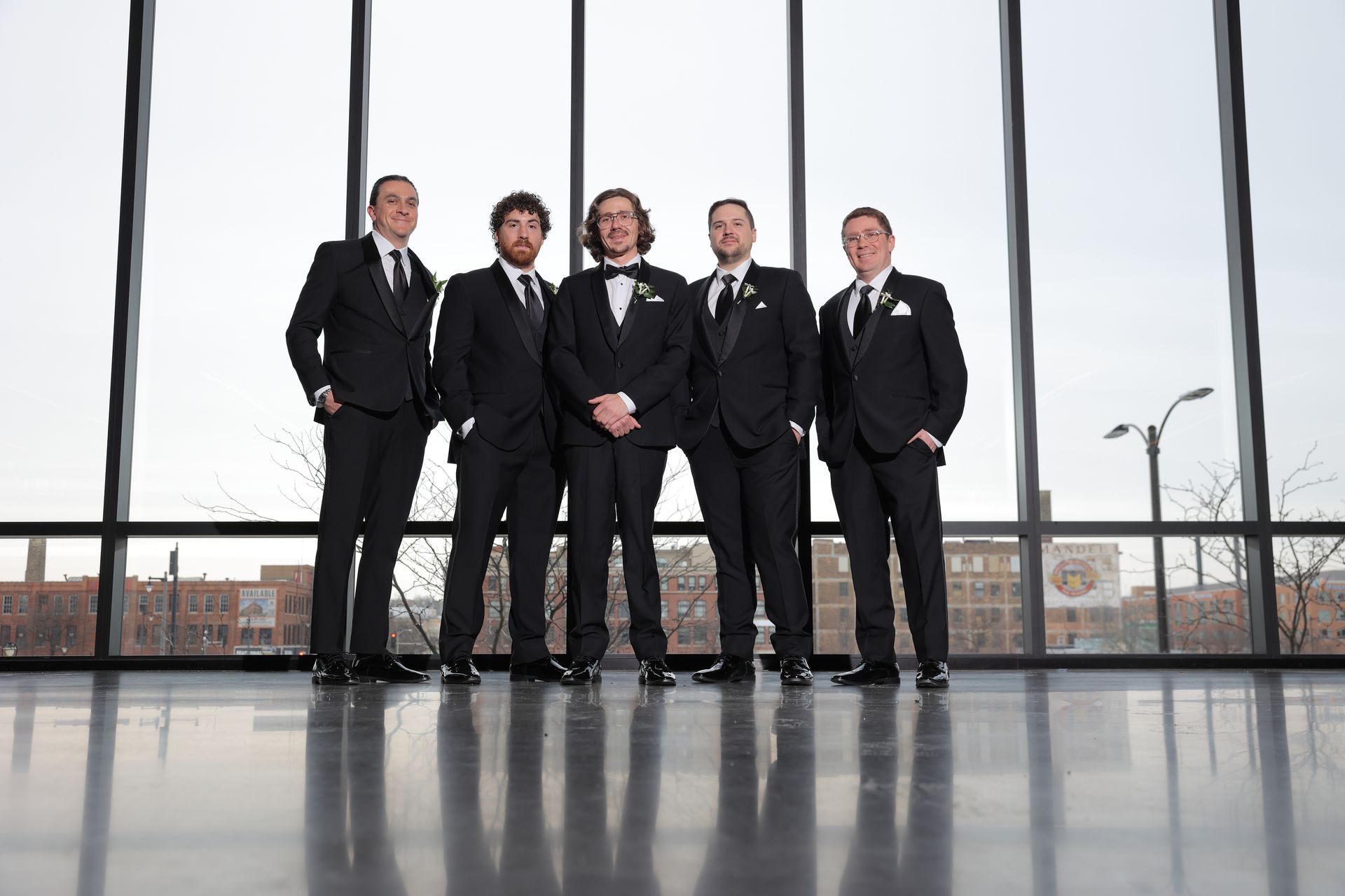 Five men in tuxedos pose indoors in front of large windows.
With Love, Wedding management, Milwaukee Wedding Coordinator