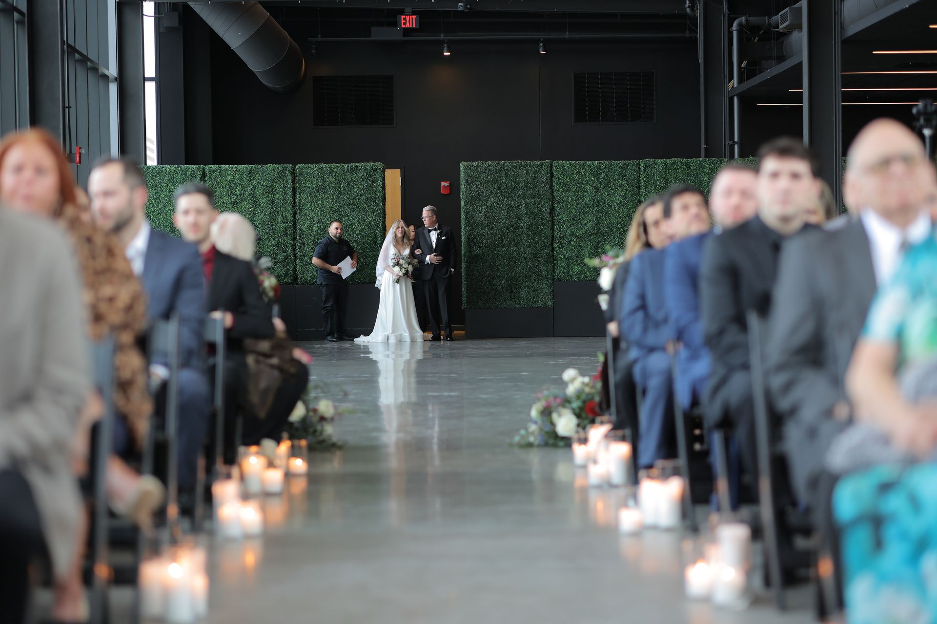 Bride walks down aisle with father; wedding ceremony in modern venue.
With Love, Wedding management, Milwaukee Wedding Coordinator