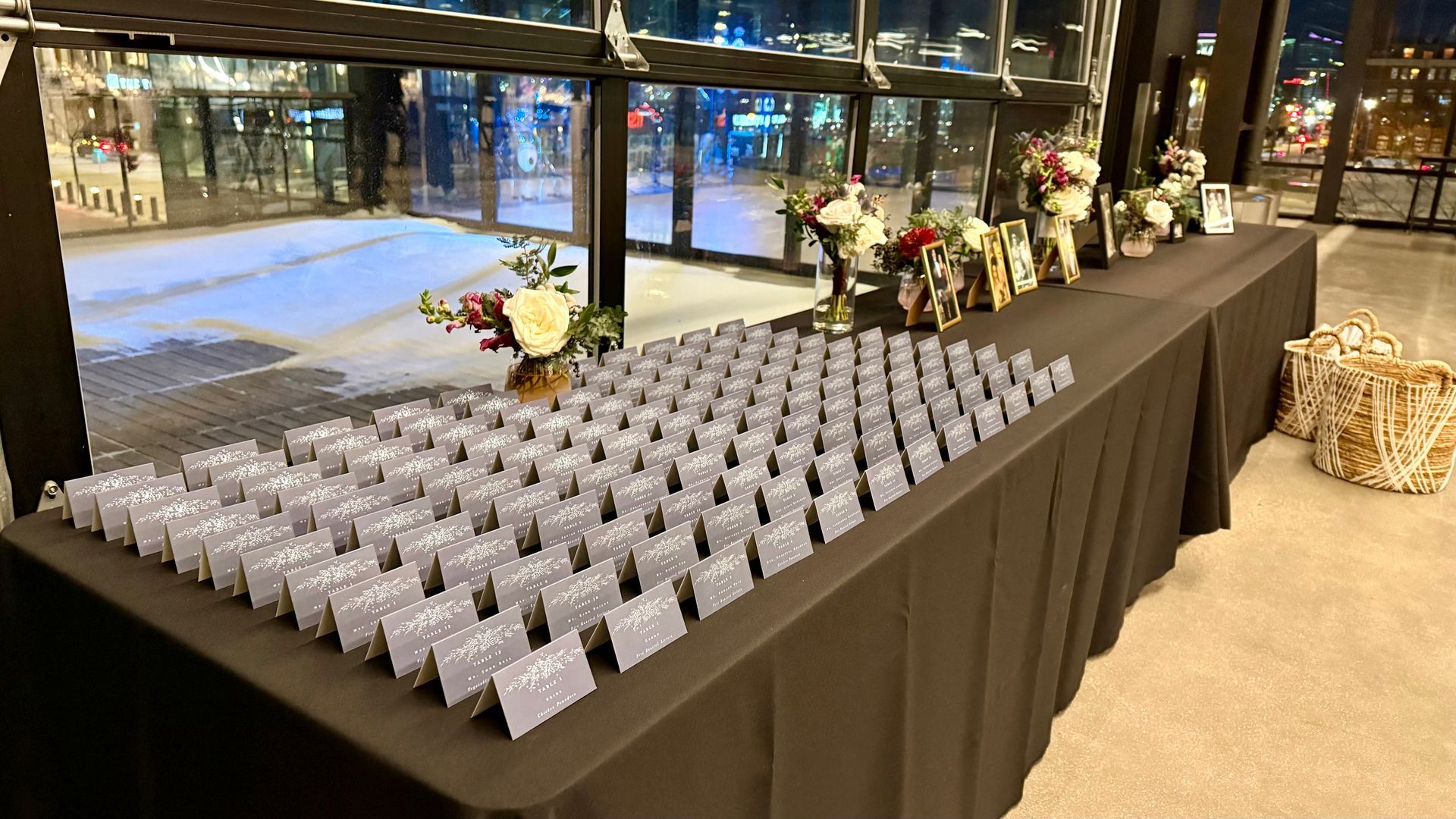 Table set with guest cards and floral arrangements inside a building.
With Love, Wedding management, Milwaukee Wedding Coordinator