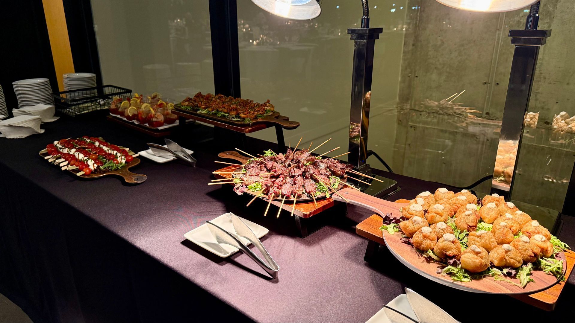 Buffet table with various appetizers, including skewers and fried balls, under warm lights.
With Love, Wedding management, Milwaukee Wedding Coordinator