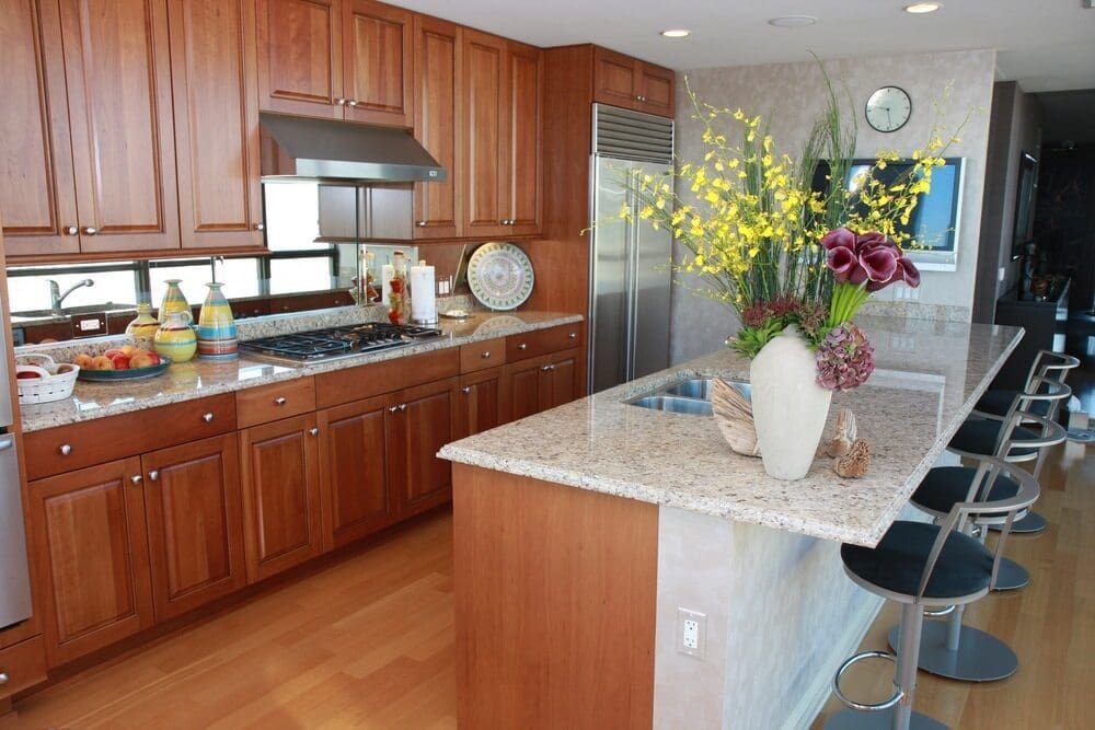 A Kitchen With Wooden Cabinets And Granite Counter Tops — Meredith Kitchens In Moffat Beach, QLD