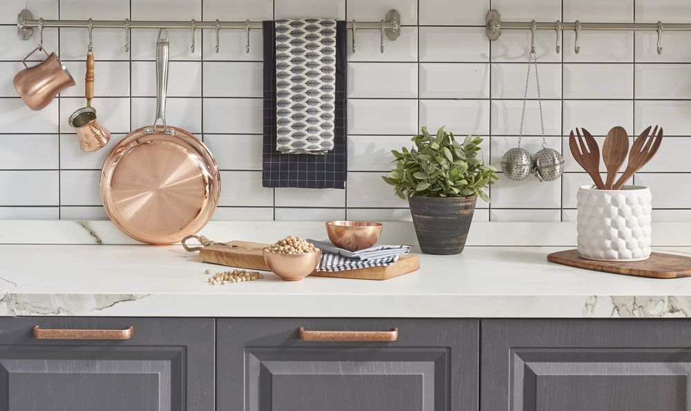 A Kitchen Counter With Pots And Pans, Utensils, A Plant And A Cutting Board — Meredith Kitchens In Moffat Beach, QLD