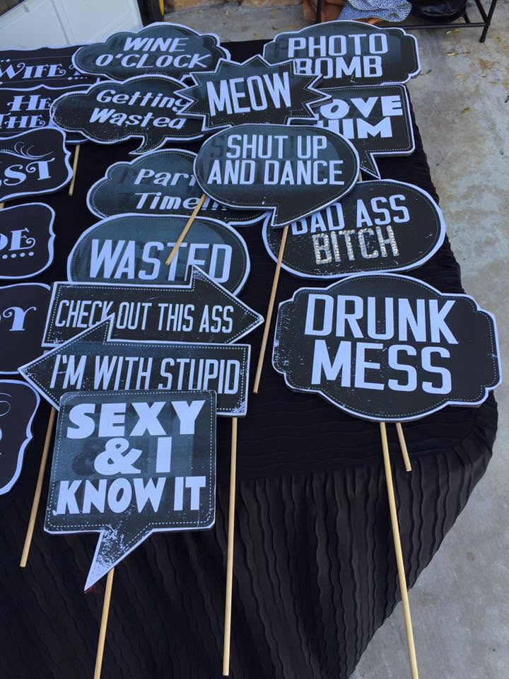 Table of novelty black-and-white profanity stickers and signs at a market stall