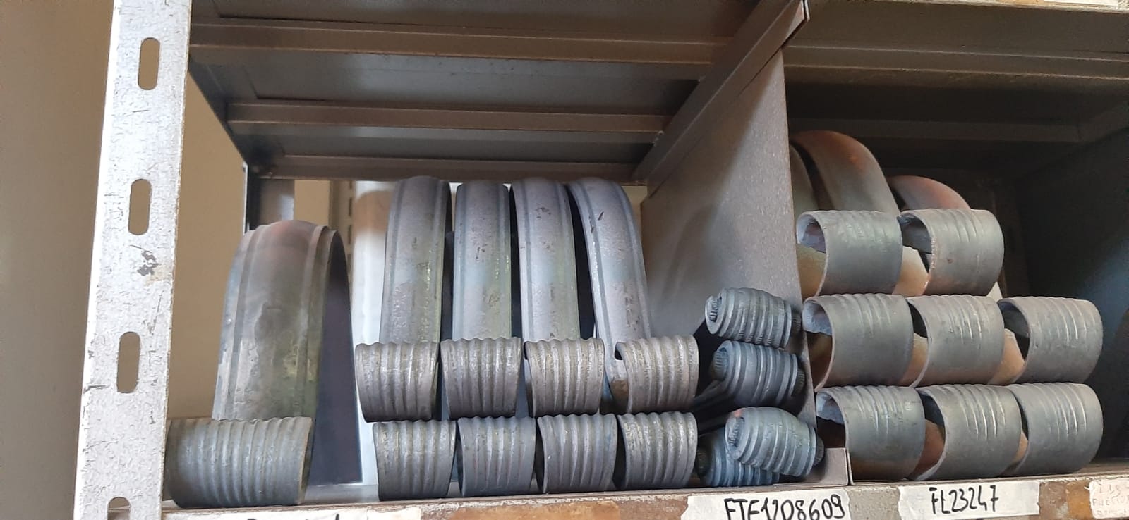 Uno scaffale con sopra un mucchio di tubi di metallo