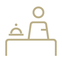 A person is sitting at a table with a tray on it.