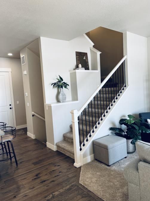 A man is plastering a wall in a room.
