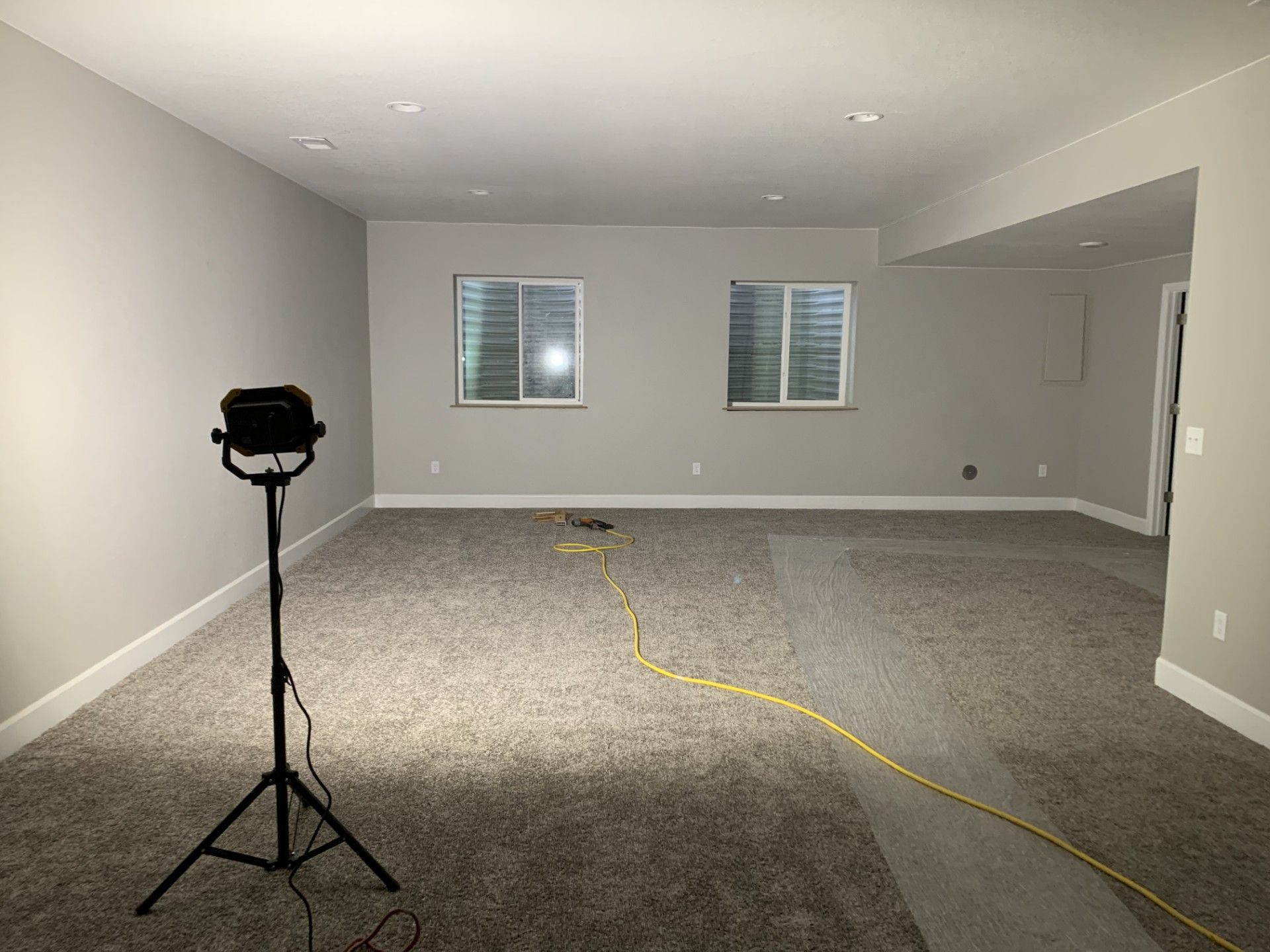 A man is painting a wall with a brush.