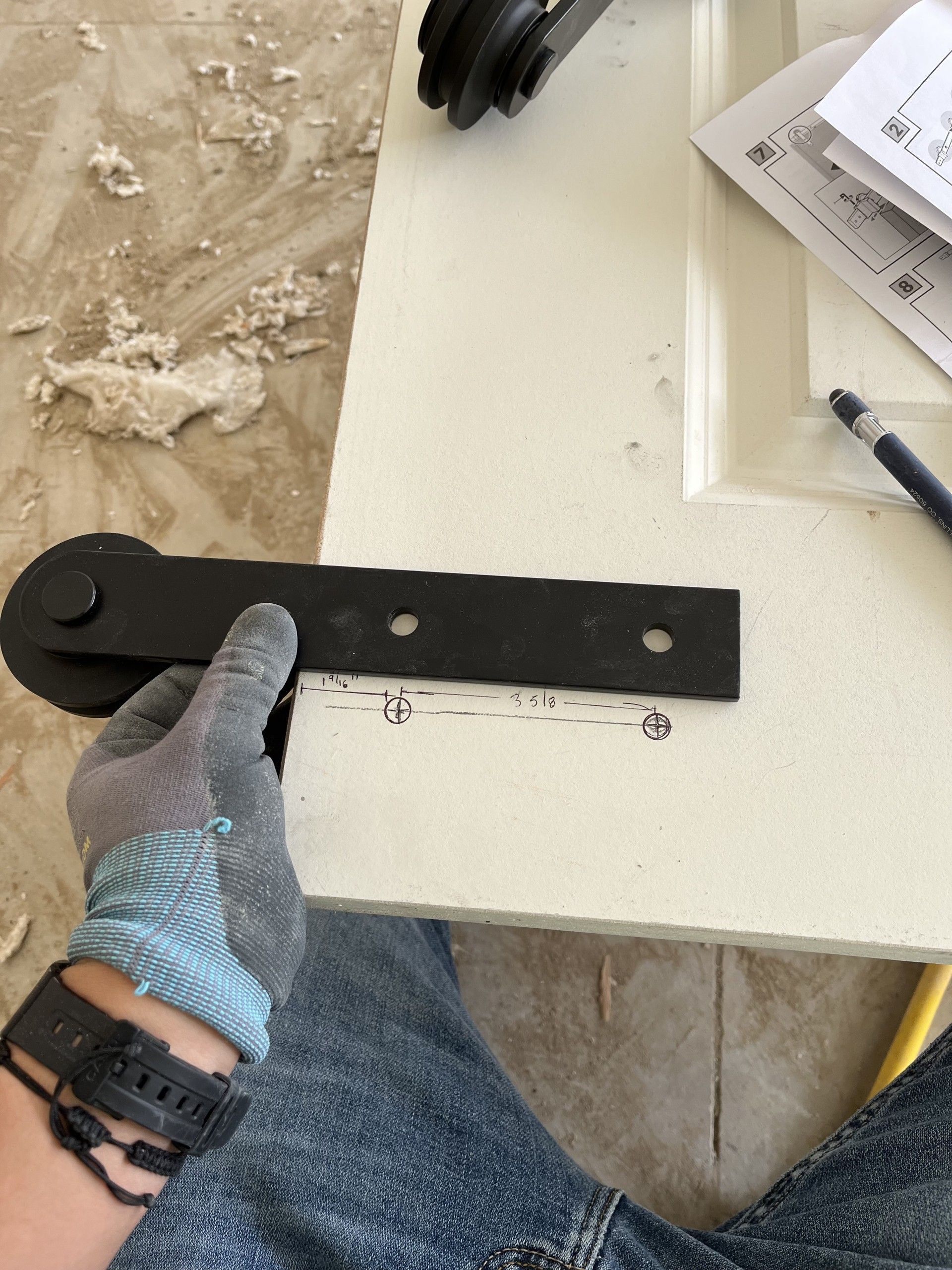 A man is plastering a wall in a room.