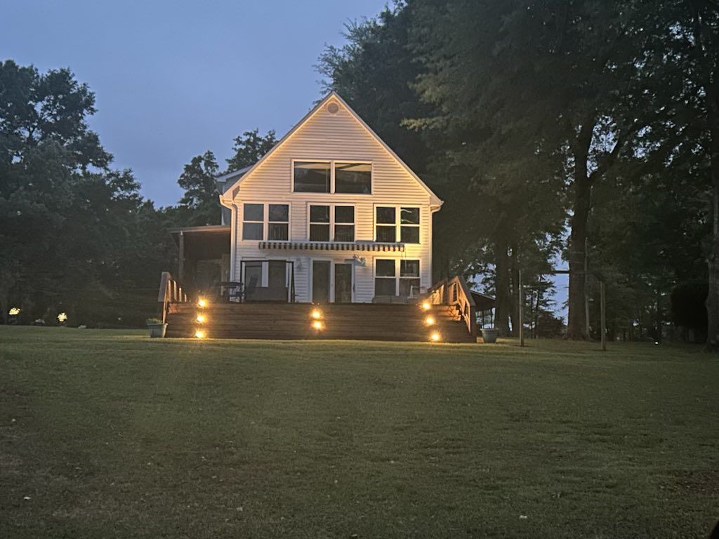 A large white house is lit up at night