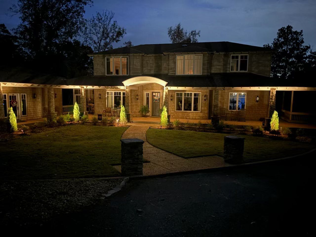 A large house is lit up at night with christmas lights.