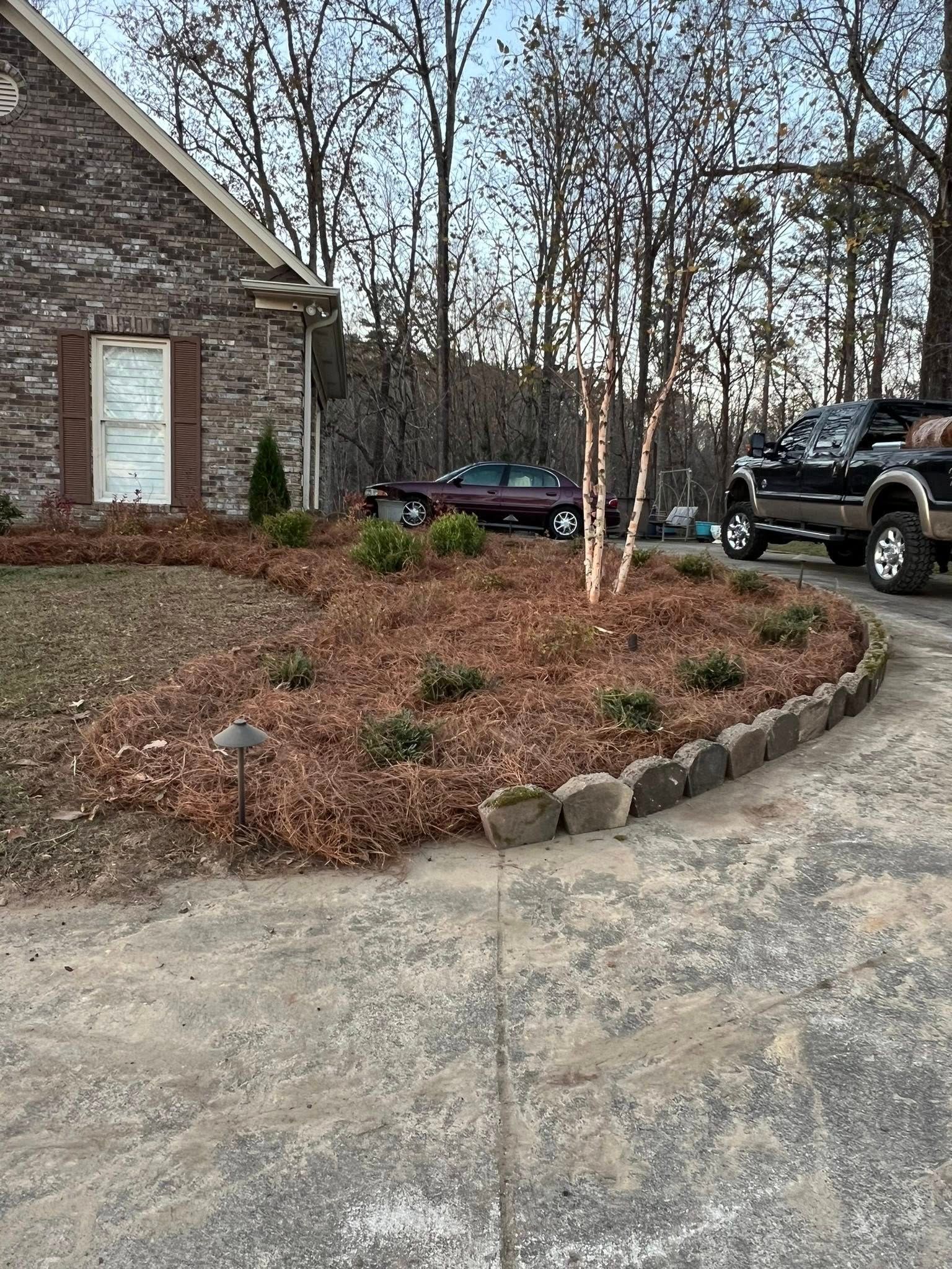 A house with a driveway and a truck parked in front of it.