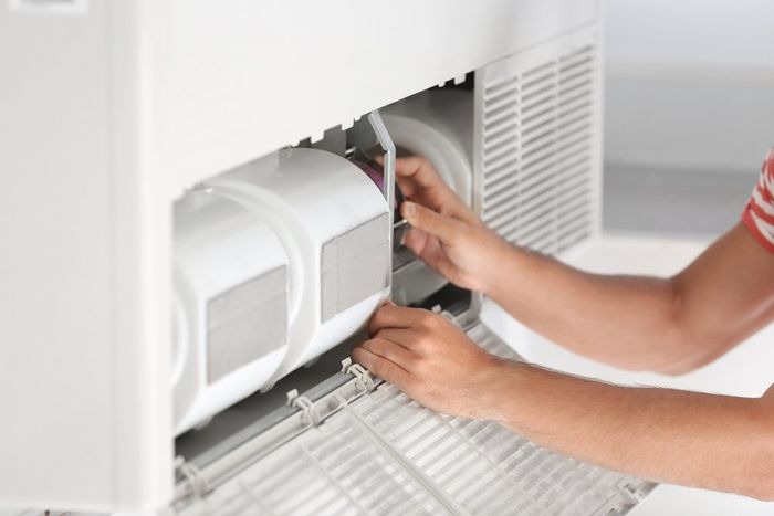Fixing Air Conditioner Unit — Air Conditioning Services in Wollongong, NSW