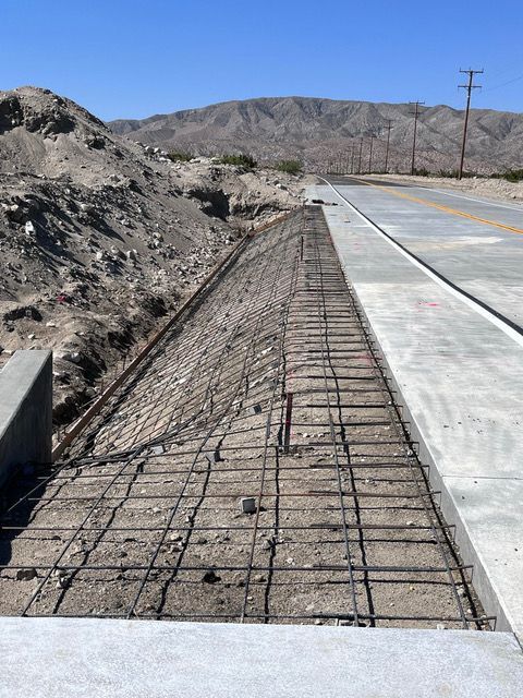 A concrete walkway is being built next to a road.