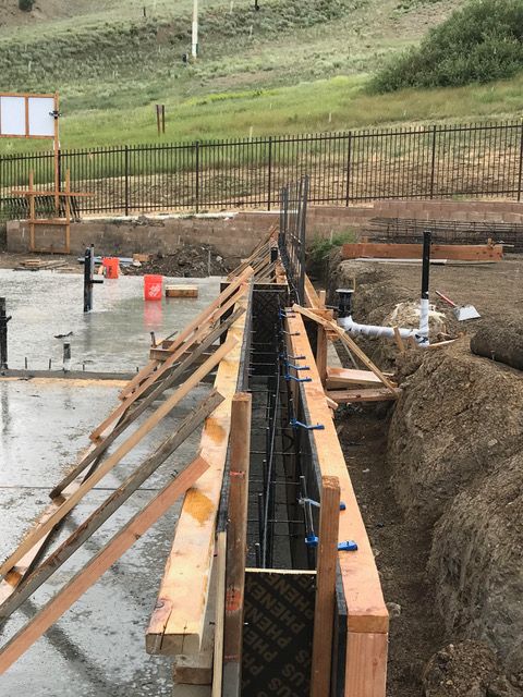 A construction site with a fence and a lot of wood
