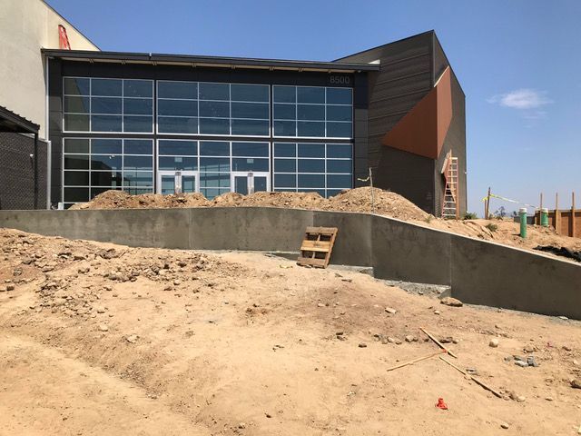 A large building with a lot of windows is under construction.