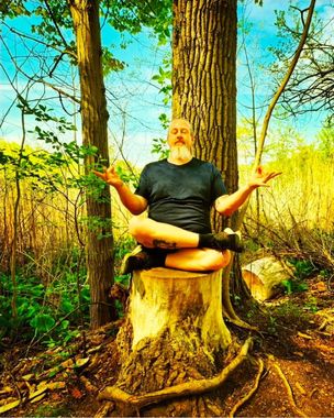 A woman is sitting on the floor wearing a relax shirt.