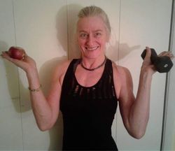 A woman is sitting on the floor wearing a relax shirt.