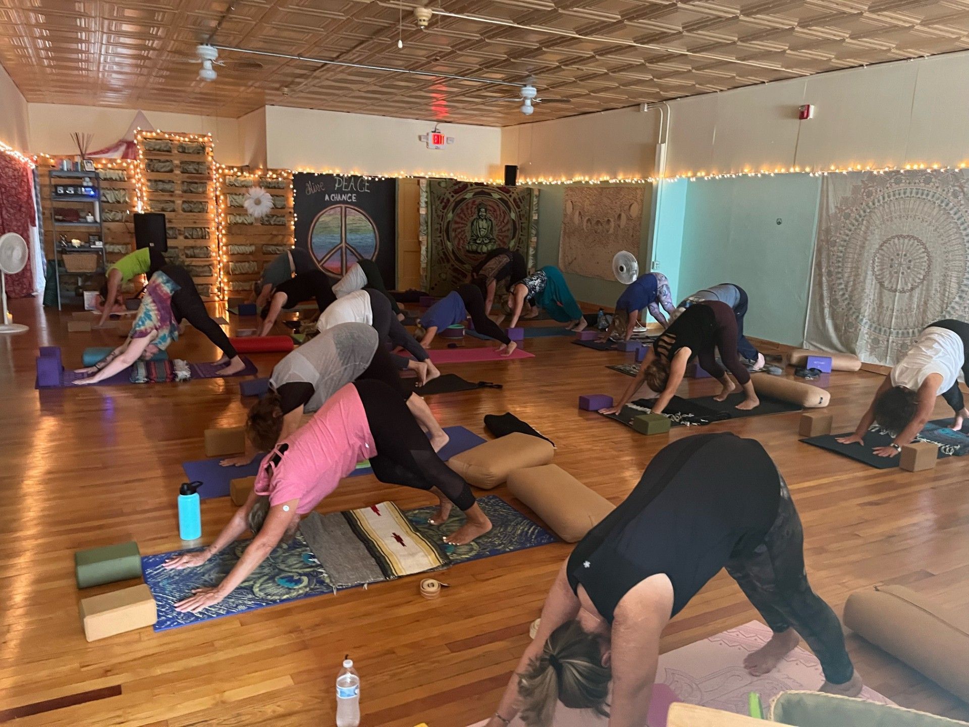 A group of people are doing yoga in a room.