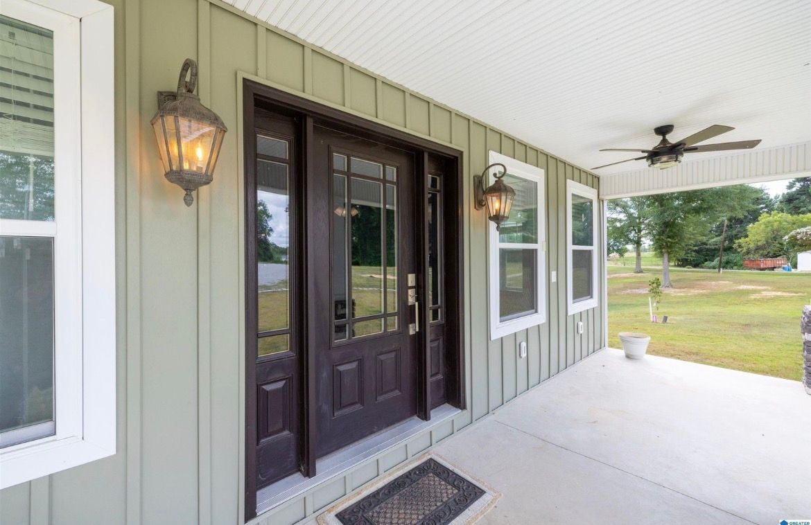 Two-story weathered wooden building with small tower in a desert landscape.