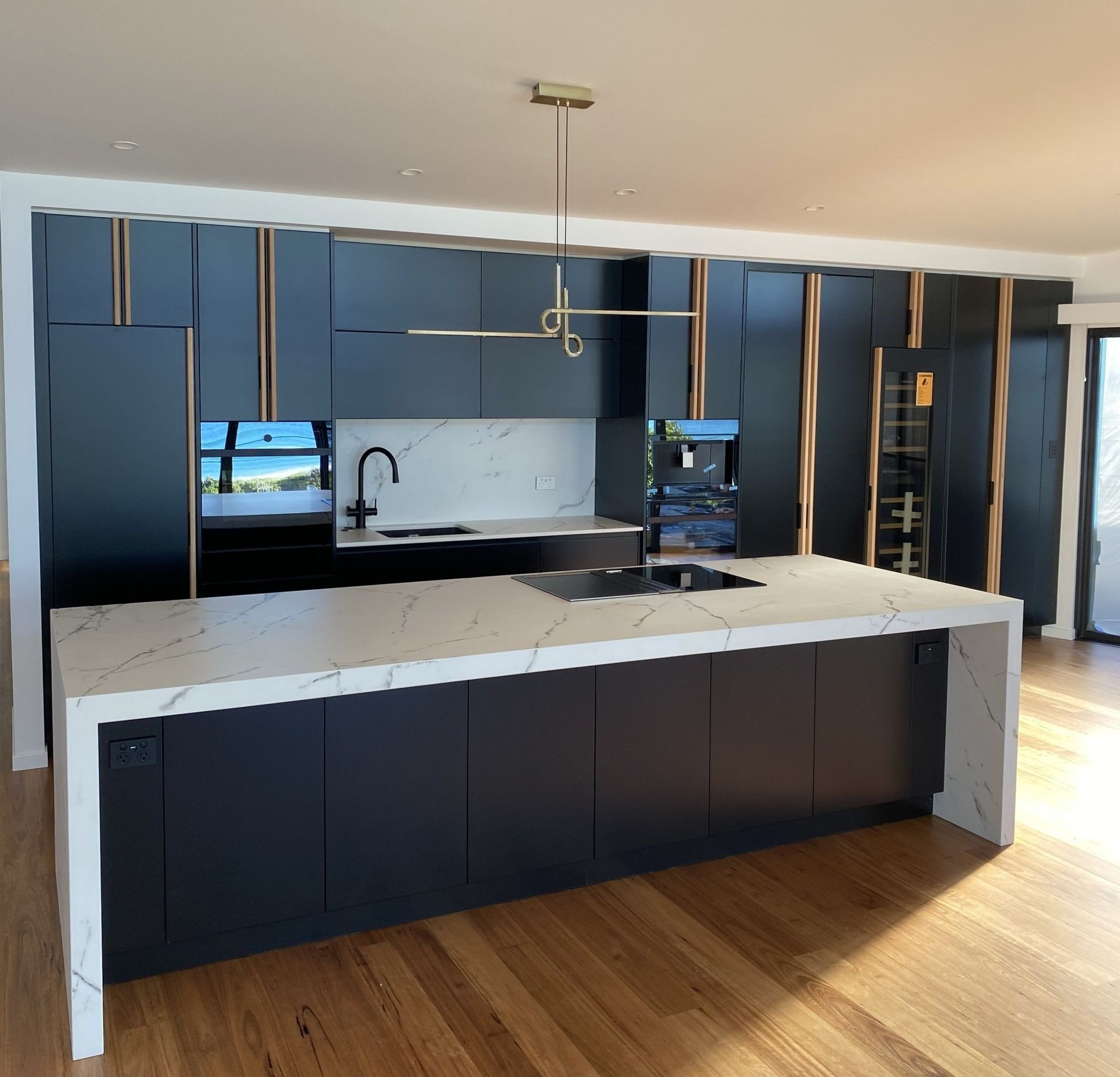 Black Color Of The Kitchen With Wooden Floor - Renovation Specialist in Forster, NSW