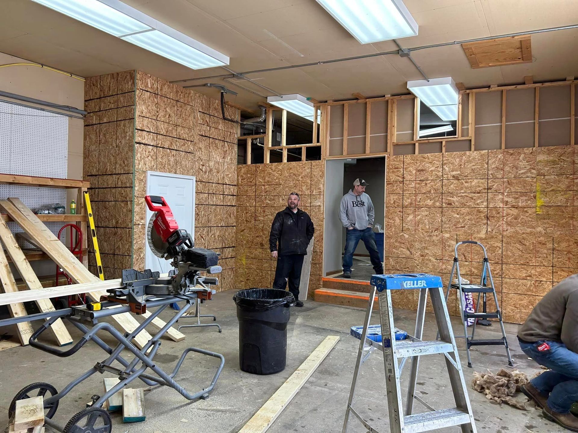 A Group Of Men Are Working On A Building In A Garage | Park Falls, WI | Park Falls Building