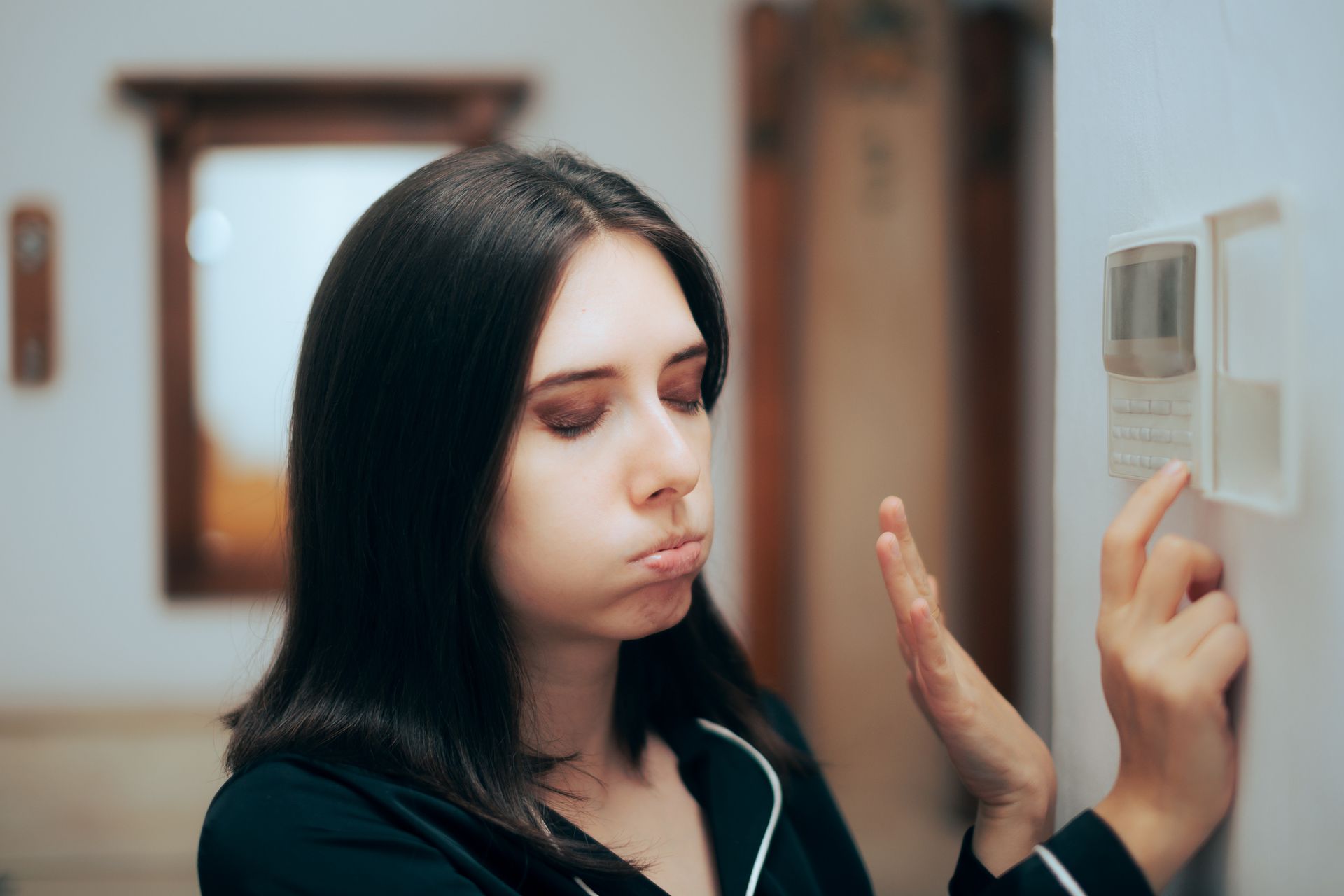 Woman Feeling Hot Setting the Room Temperature to be Lower.