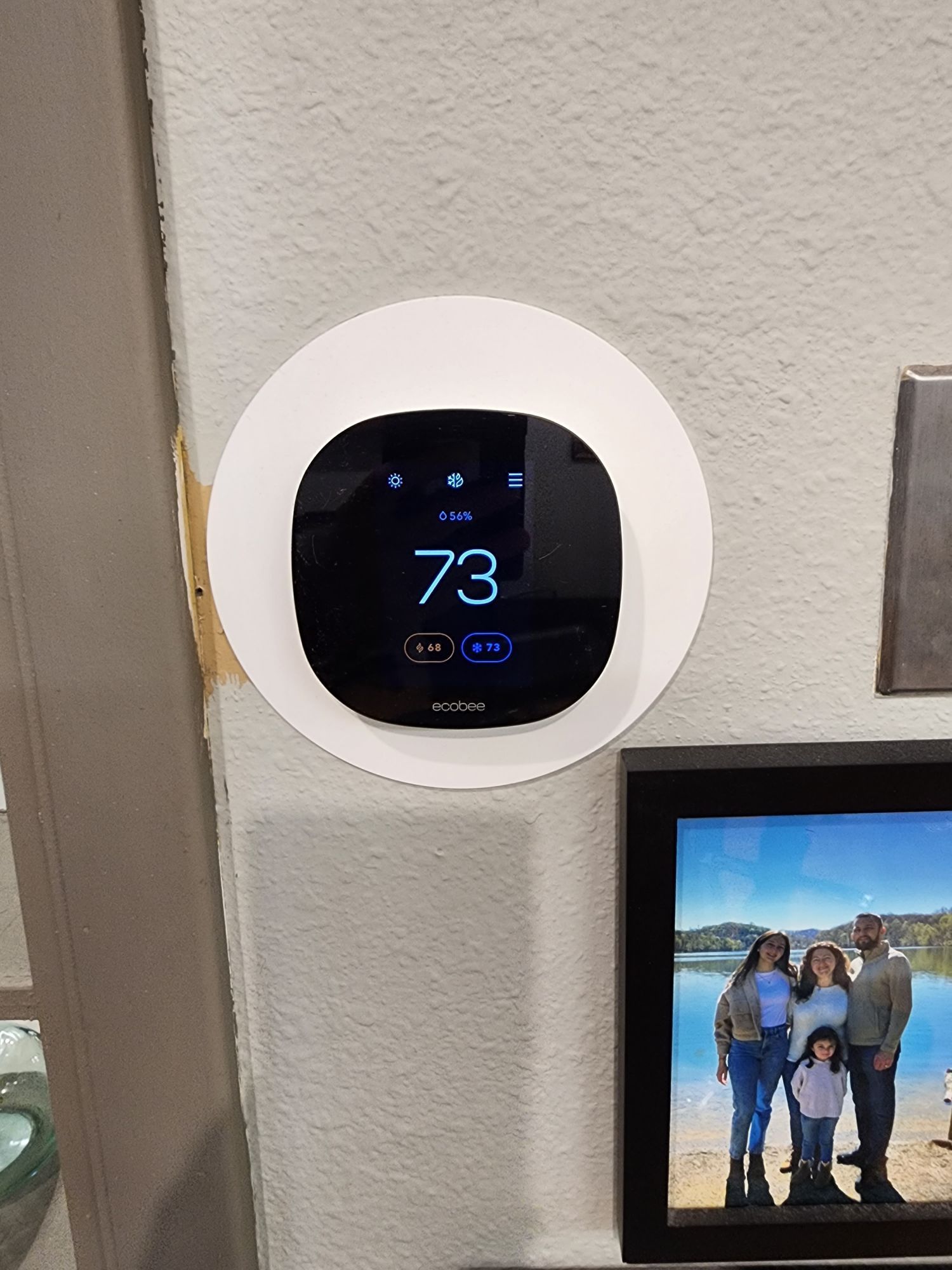 Smart thermostat being adjusted.